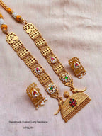 A long gold-tone necklace with geometric lattice links, peacock motifs and a broad fringed pendant.